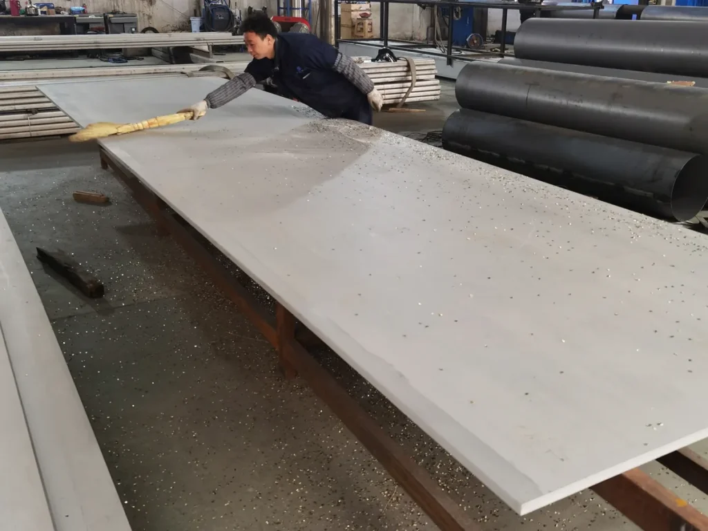 Worker checking a 304 stainless steel plate