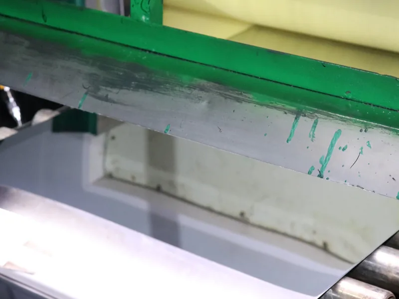 Stainless steel coil running through our processing line