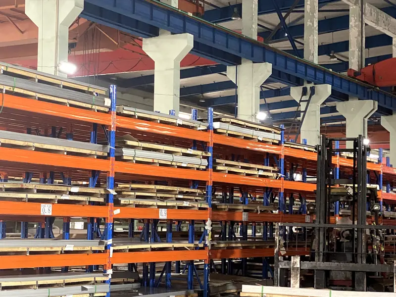 Stainless steel sheet stock on racks with forklift